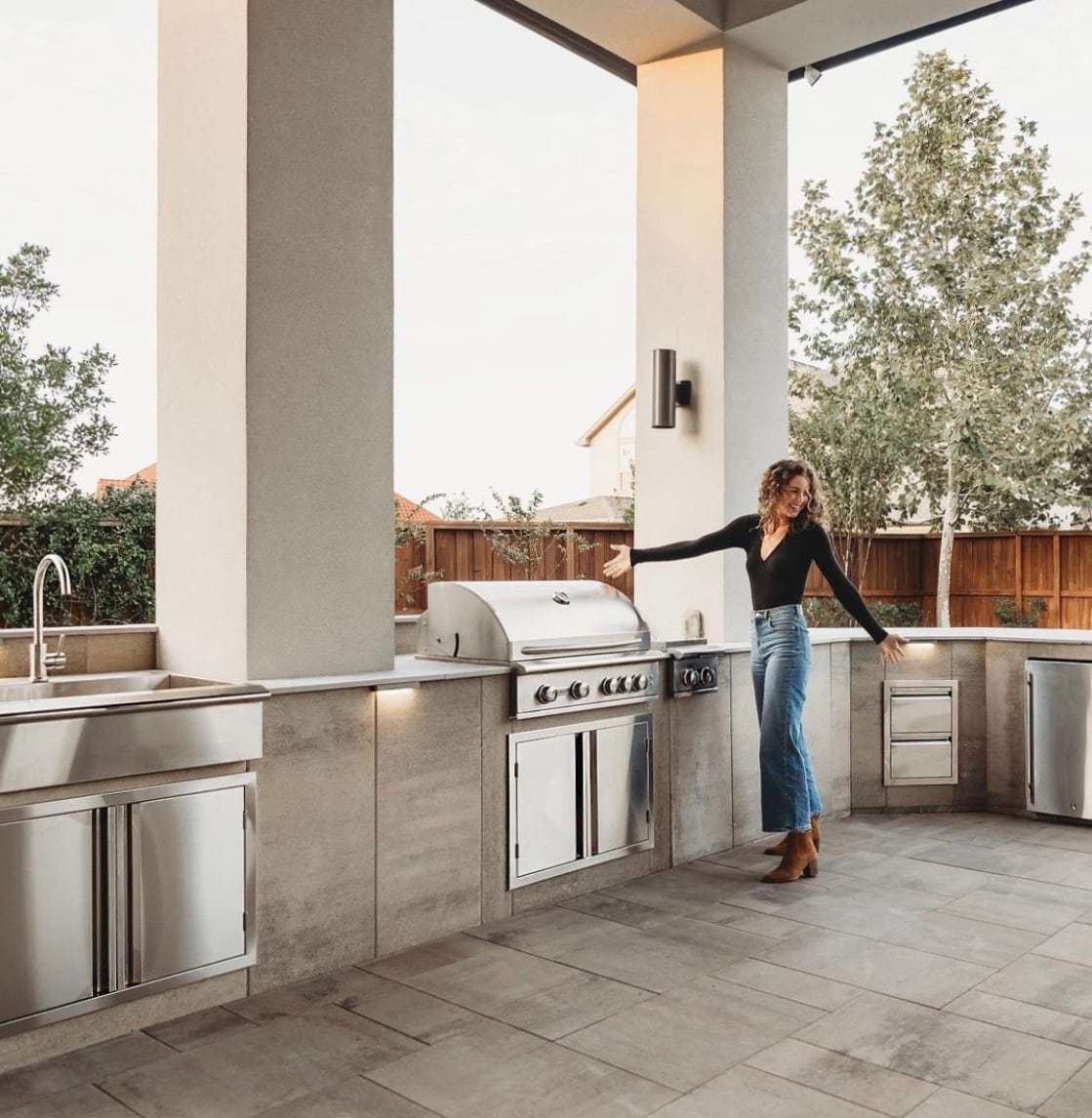 Lauren Beavers standing in her Belgard outdoor kitchen